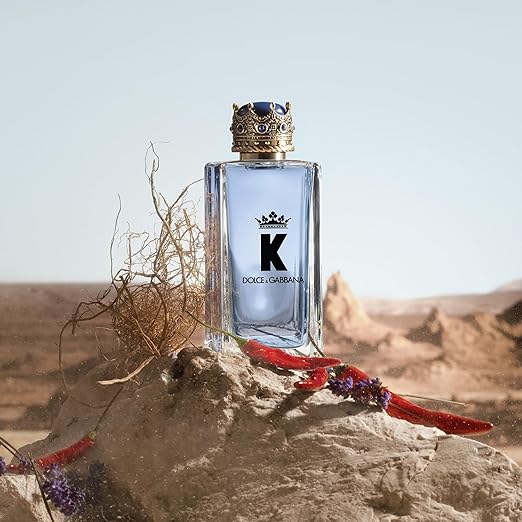 Dolce & Gabbana K perfume bottle on a desert background