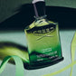 Creed Original Vetiver perfume bottle on a green background