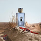 Dolce & Gabbana K perfume bottle on a desert background
