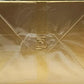 Gold rectangular object with a logo on a gold background