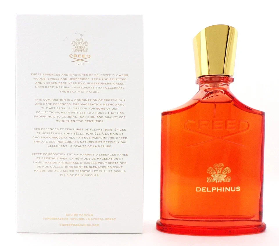 Orange Creed Delphinus perfume bottle with gold cap and white box on a white background