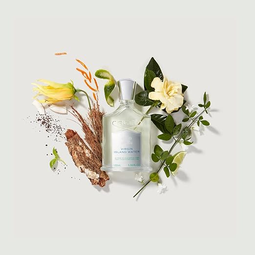 Perrier mineral water bottle with flowers and herbs on a light background