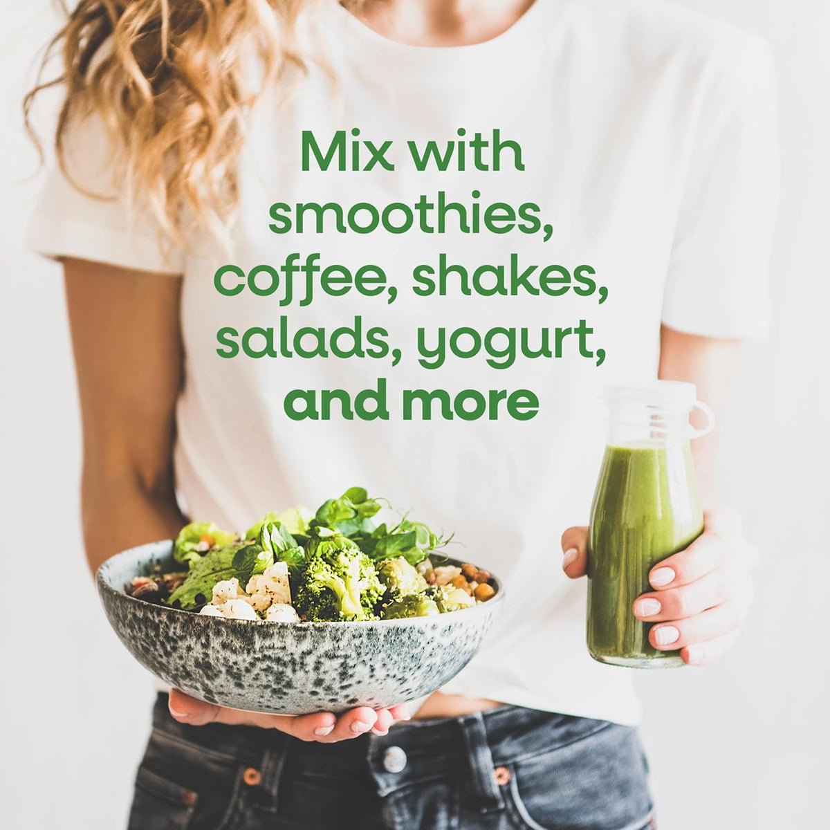 Person holding a bowl of salad and a bottle of green juice with text about using it with smoothies and other foods.