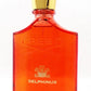 Red Delphinus perfume bottle with gold cap on a white background