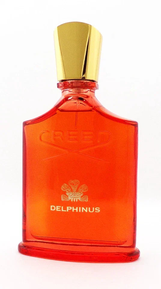 Red Delphinus perfume bottle with gold cap on a white background