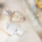 Two perfume bottles with a blurred background